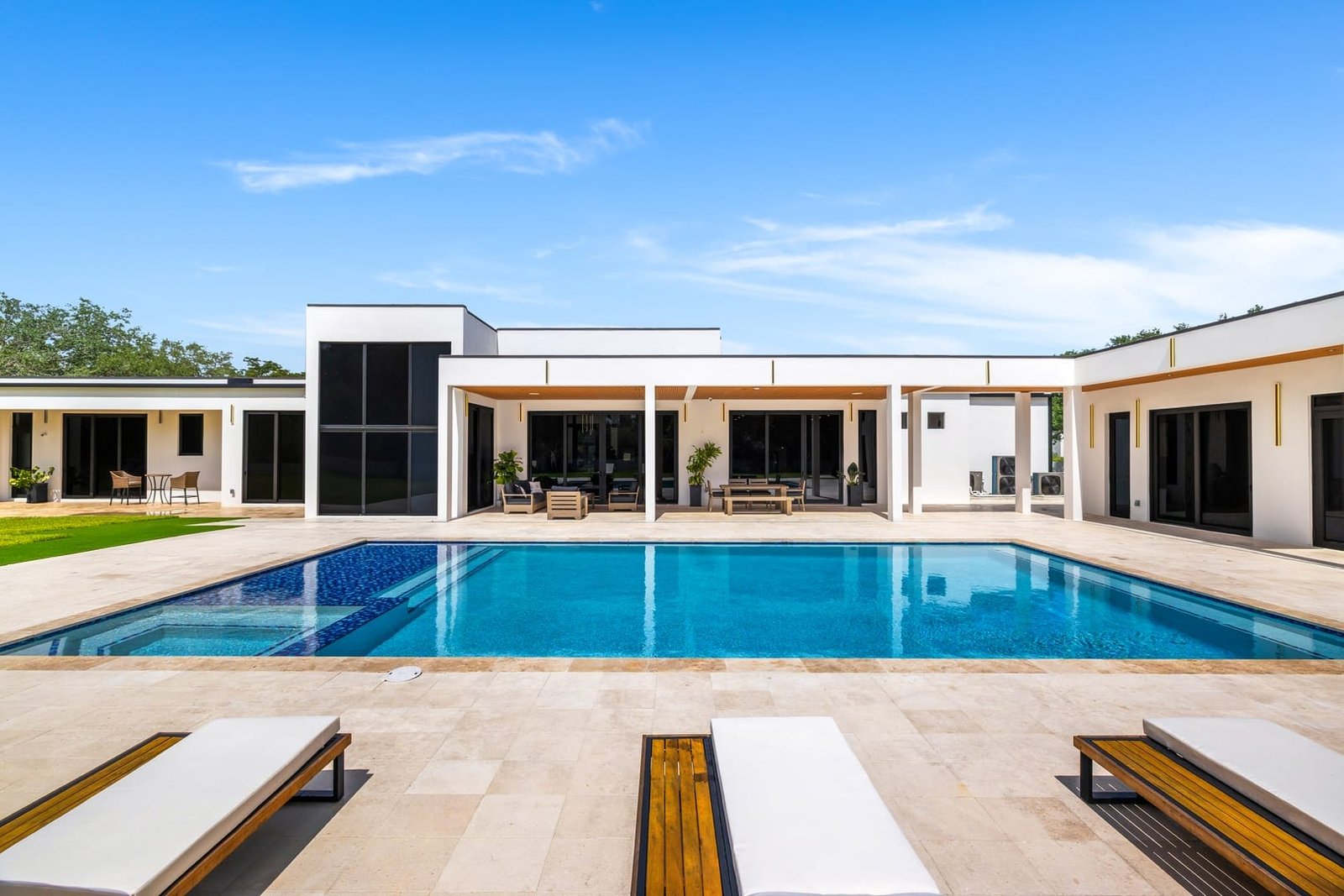 Daytime pool and yard at a Cooper City luxury estate