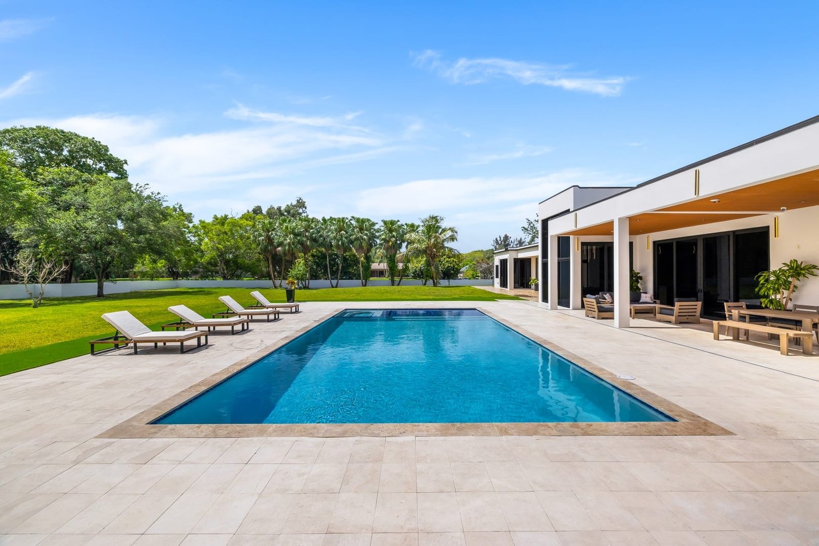 Backyard pool and lawn at a Cooper City luxury estate